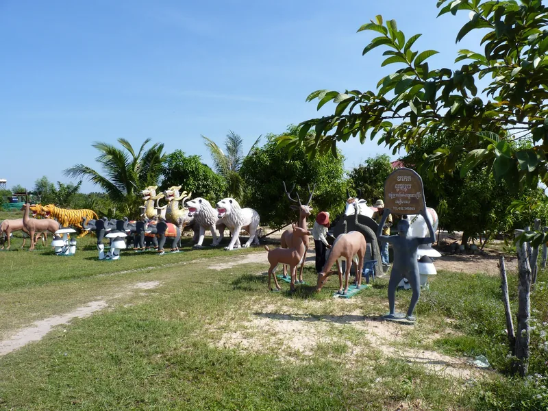 Colorful animal statues, including tigers, dragons and deer, line a roadside garden near Banteay Srei, Siem Reap.