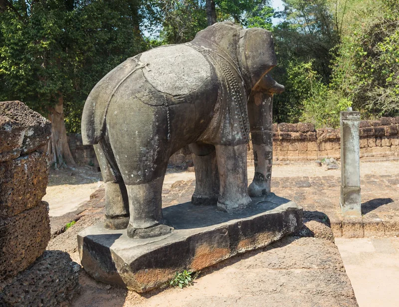 A weathered stone elephant statue stands guard at Pre Rup temple in Siem Reap, Cambodia.