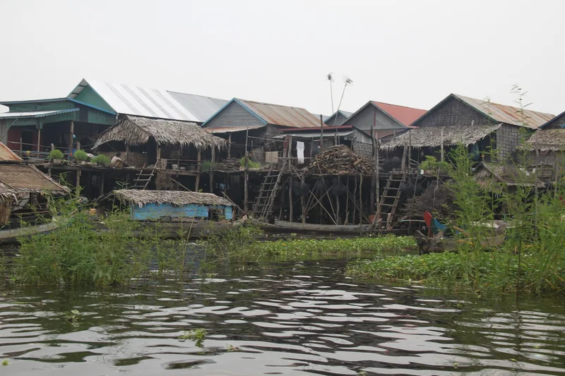Stilt houses with thatched roofs line the shore of Tonle Sap Lake near Siem Reap.